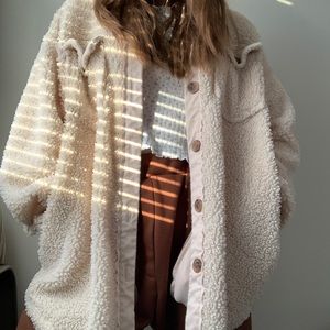 Fuzzy creme colored button-up jacket.
